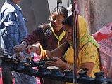 409 Muktinath Chumig Gyatsa Pilgrims Lighting Candles Hindu pilgrims light candles outside the Central Vishnu temple, Chumig Gyatsa, at Muktinath.